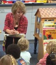 Adult person reading to children in a classroom
