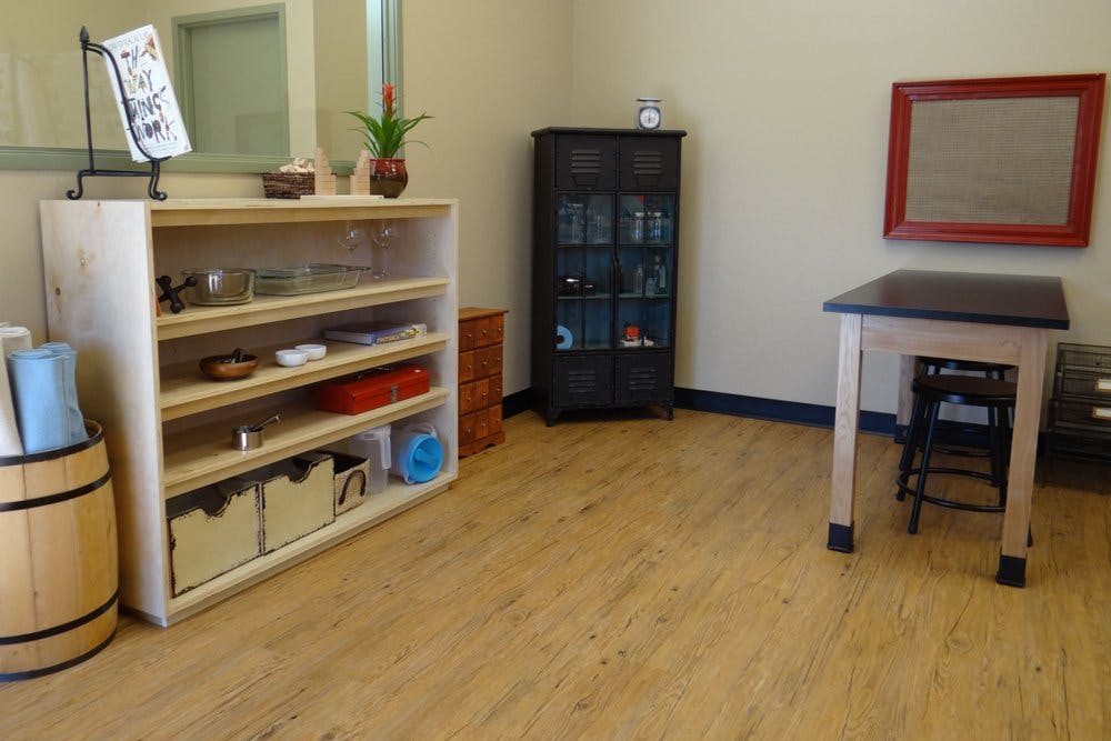 Classroom with shelves, table, and cabinet