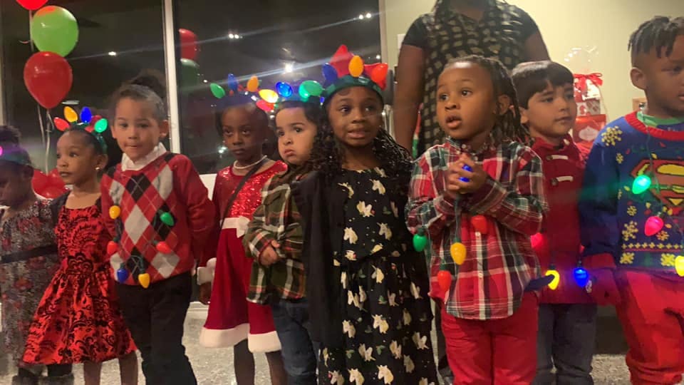 Group of children wearing festive clothing with lights
