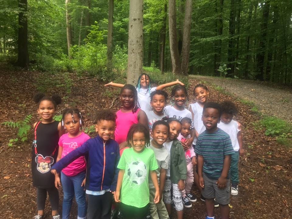 Group of children standing on a path in a forest