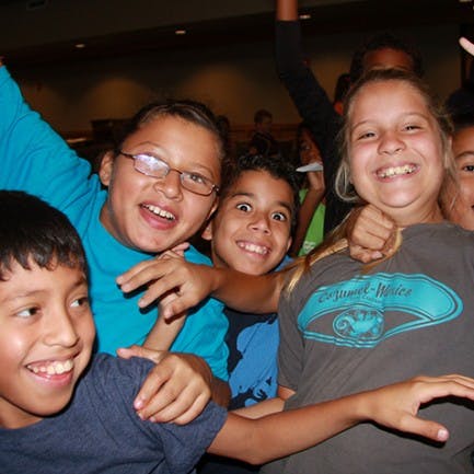 Group of children smiling and posing together