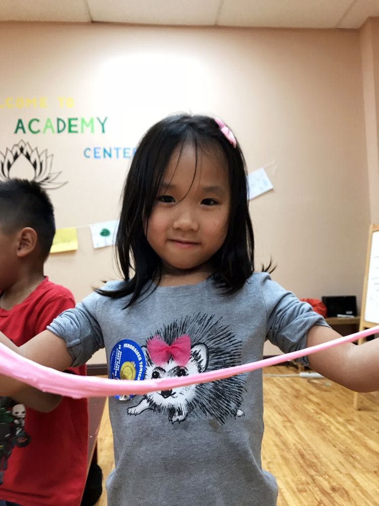 Child holding pink slime