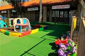 Outdoor playground with colorful play structures and toys on green turf