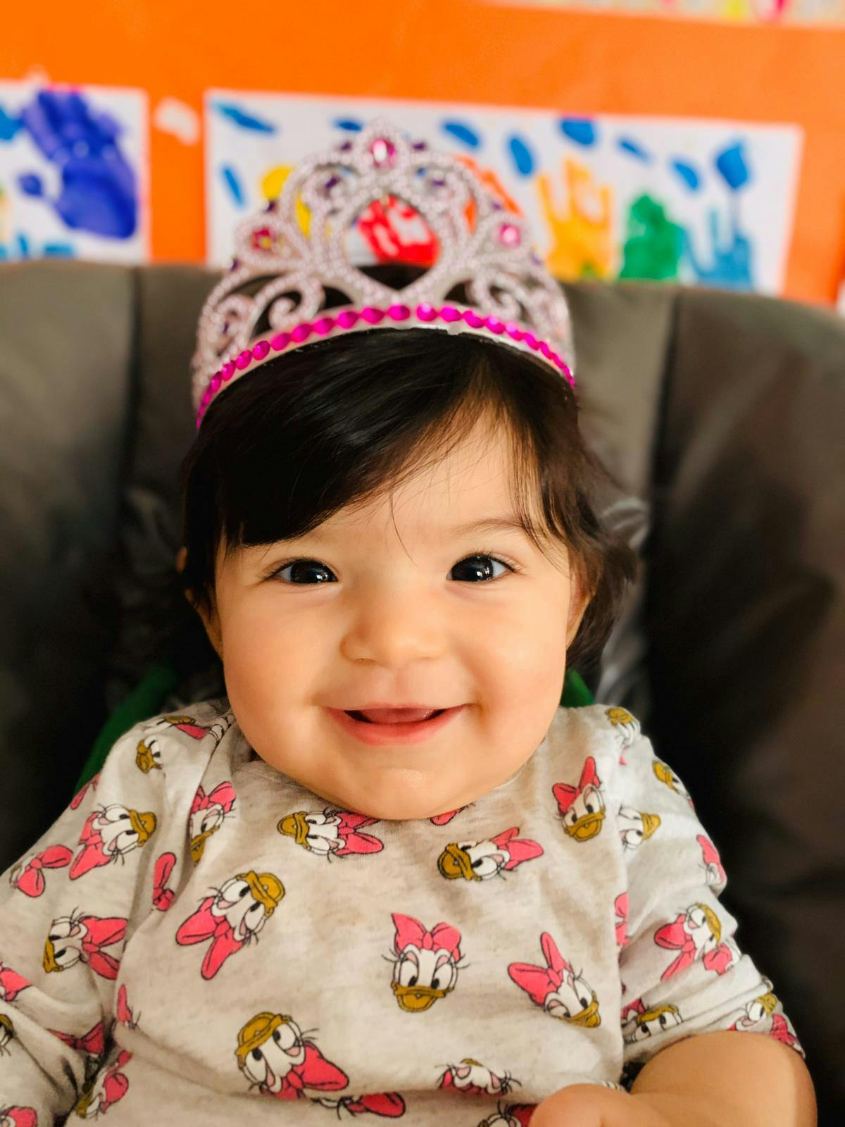 Child wearing a crown and patterned shirt