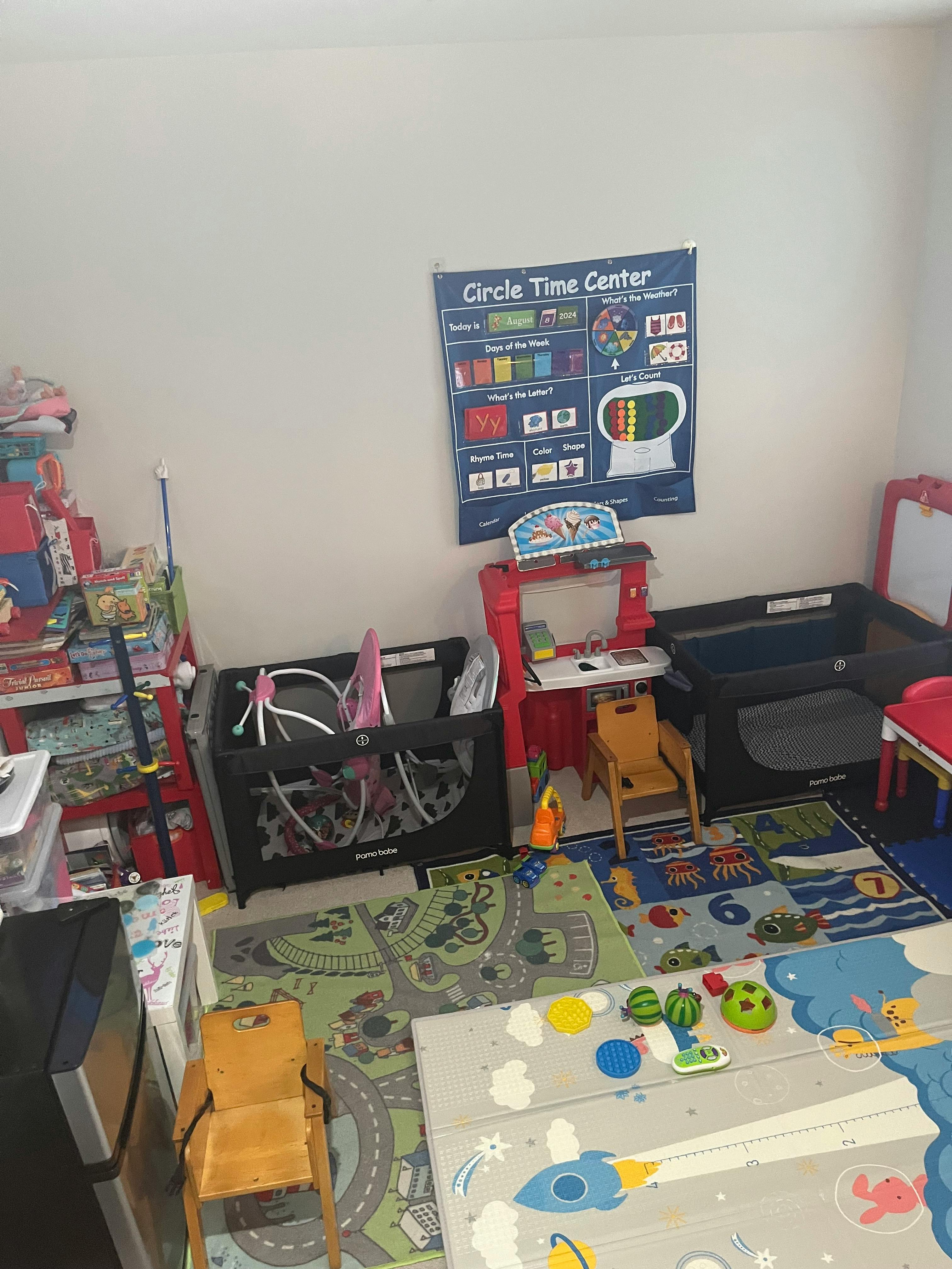 Playroom with playpens, small chairs, and a "Circle Time Center" poster