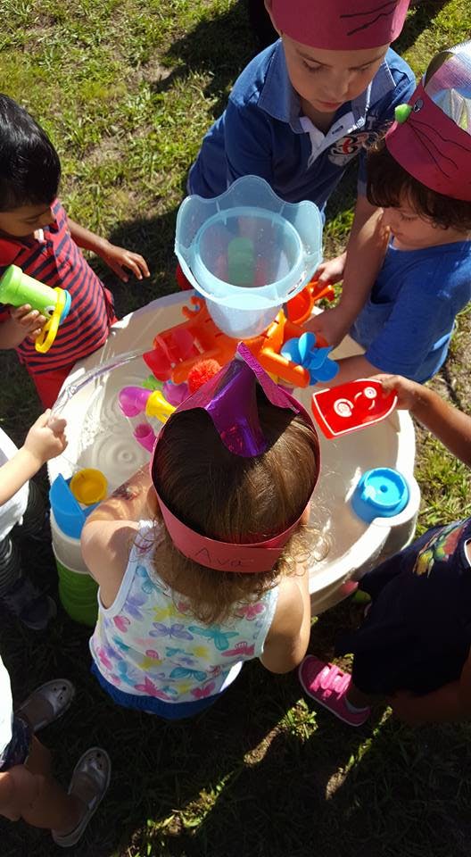 Children playing with a water table outdoors