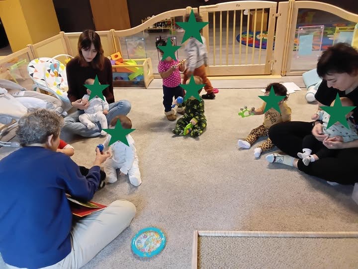 People with children in a carpeted daycare setting