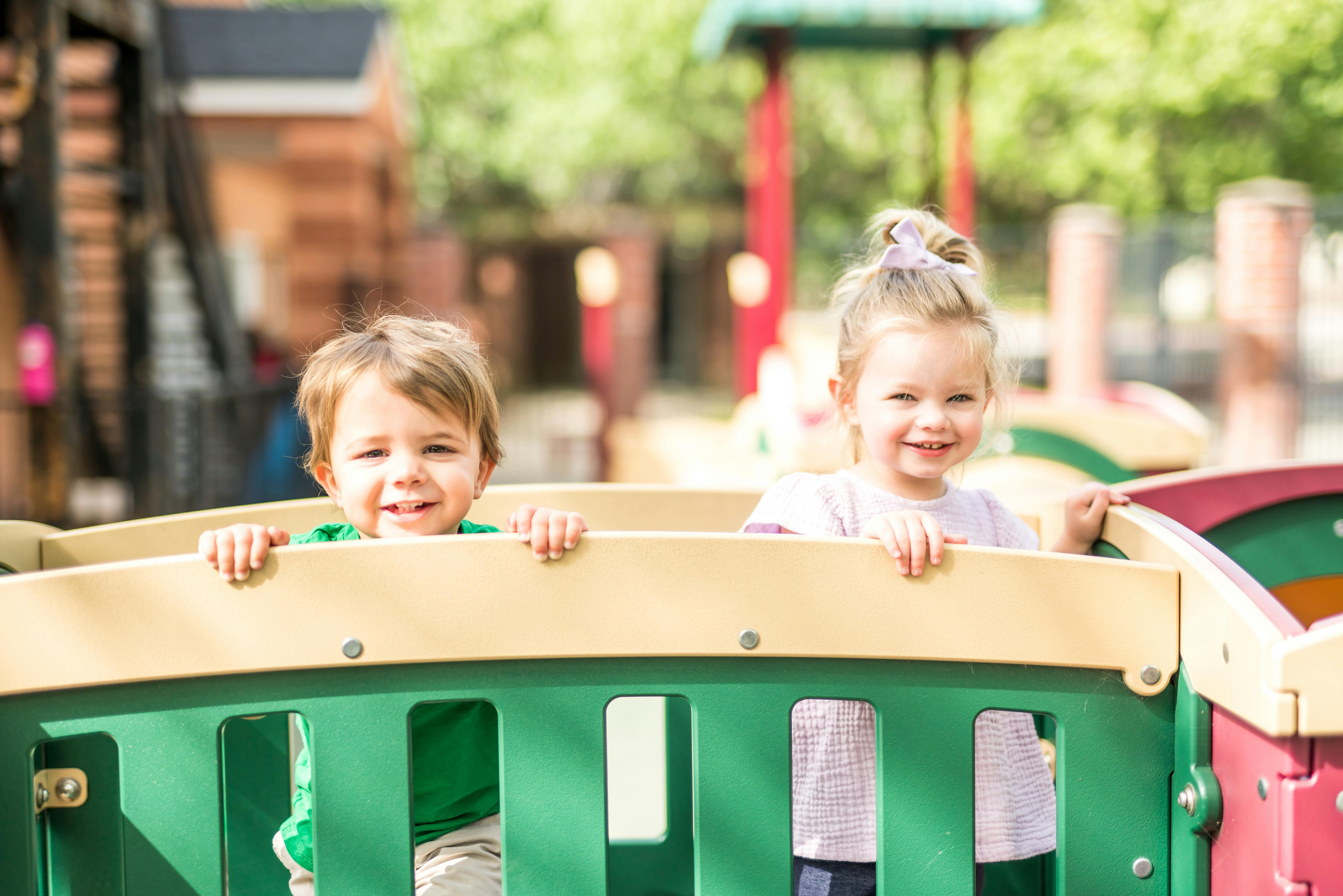 Two children on a playground structure
