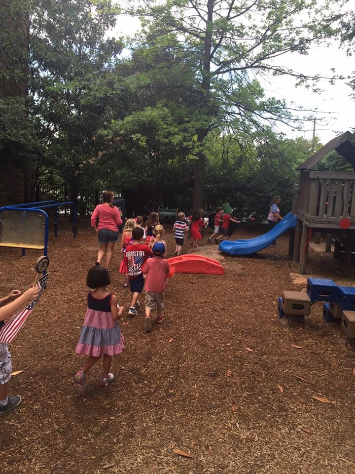 Adult and children walking on a playground