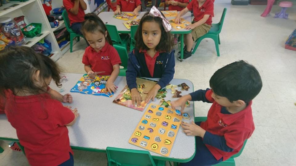 Children playing with puzzles at a table