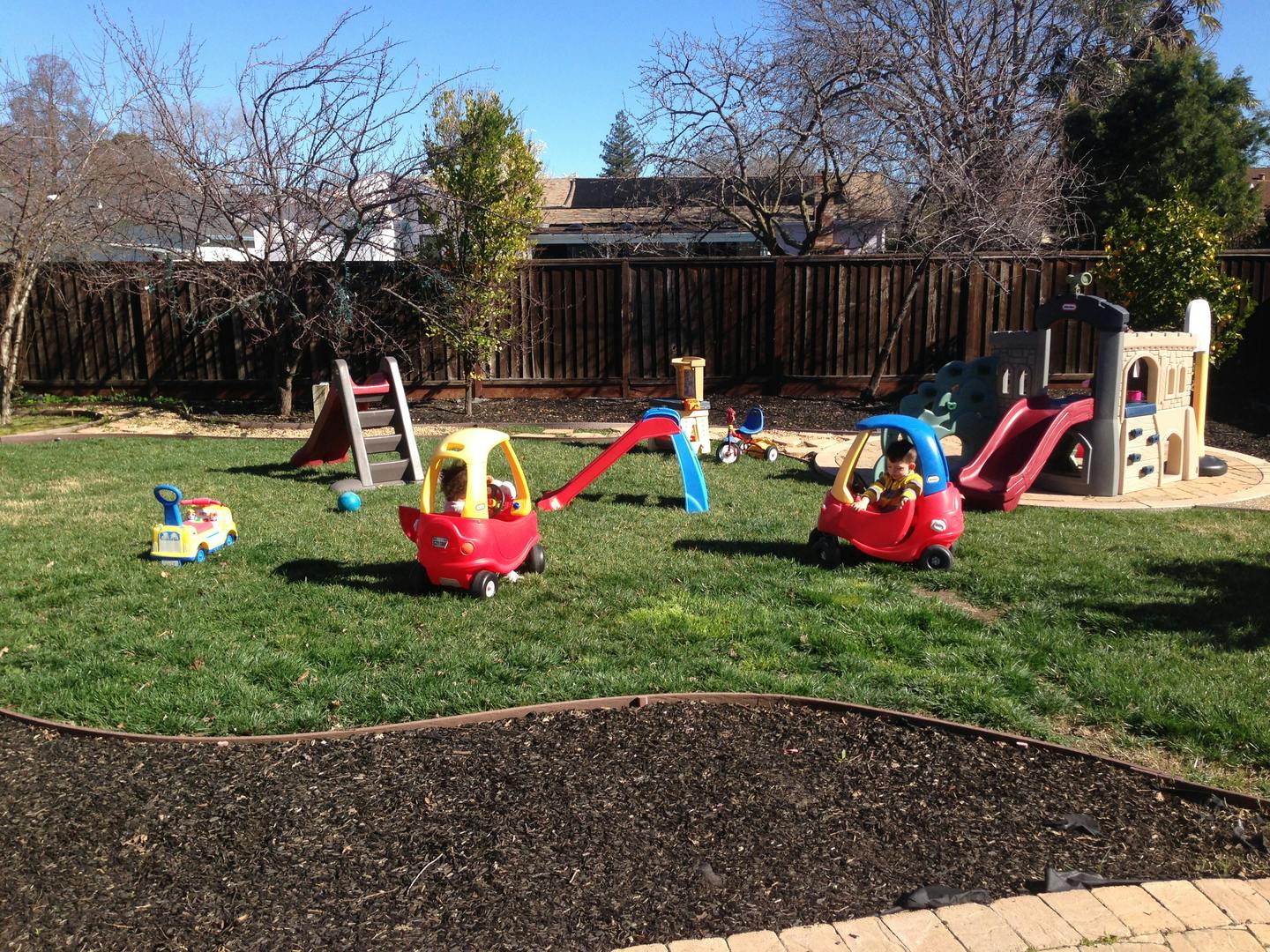 Playground with toy cars and slides on grass