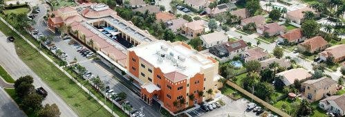 Aerial view of a building complex with surrounding residential area