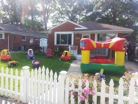 Front yard with bounce house and toy cars