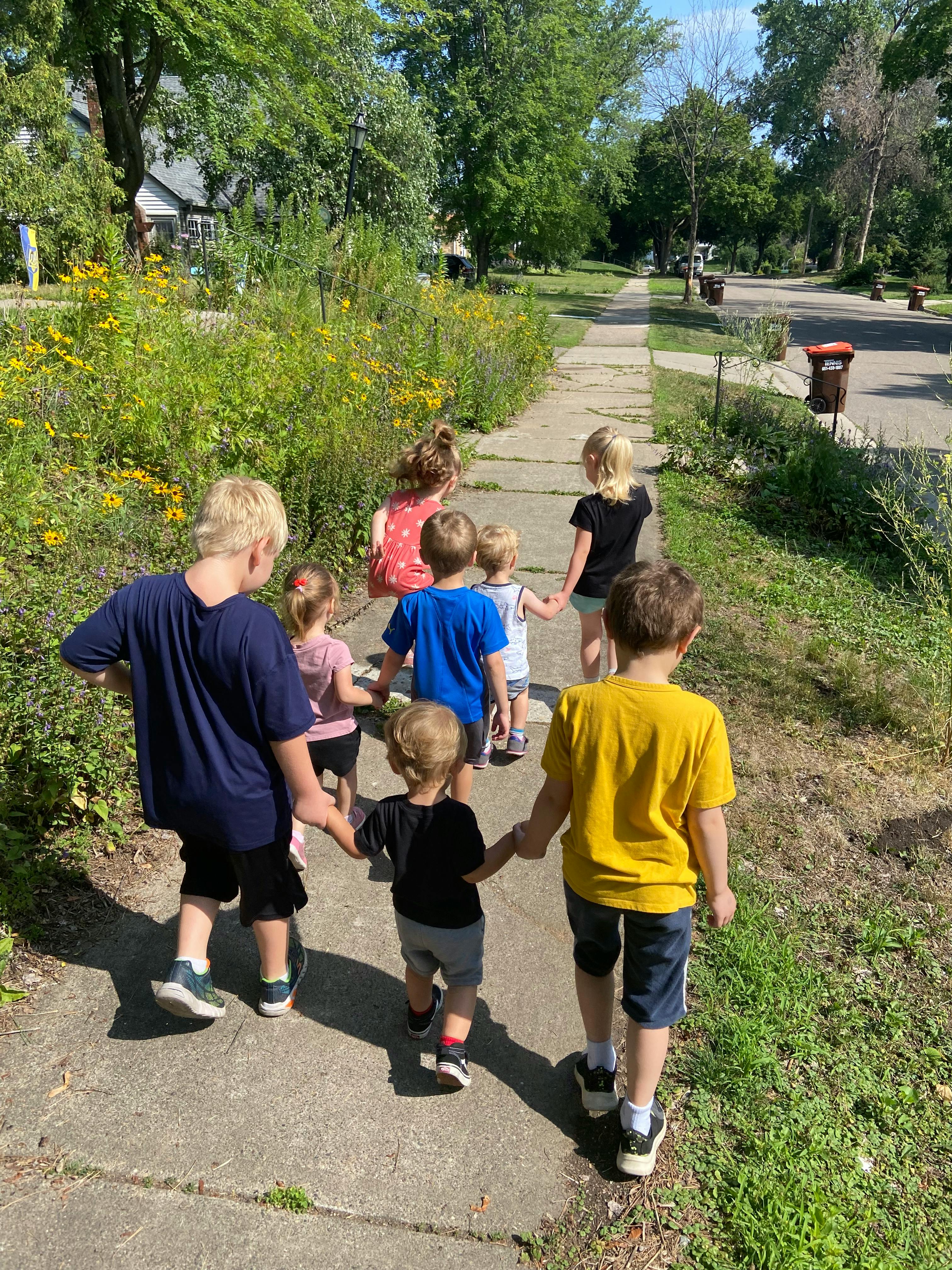 Group of children walking on a sidewalk