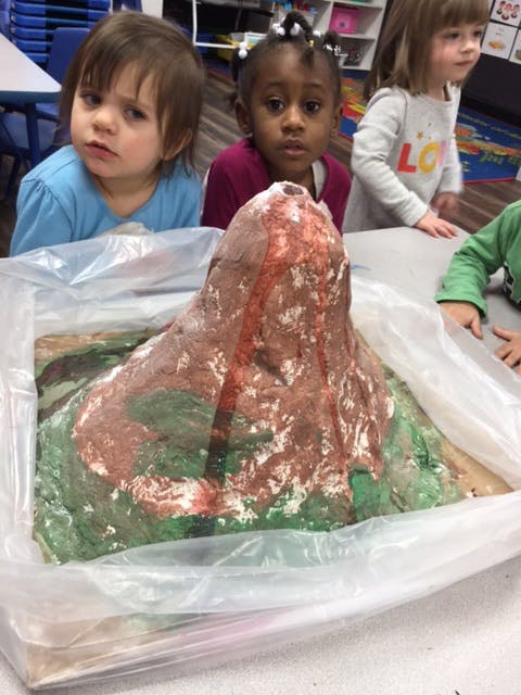 Children watching a volcano science project