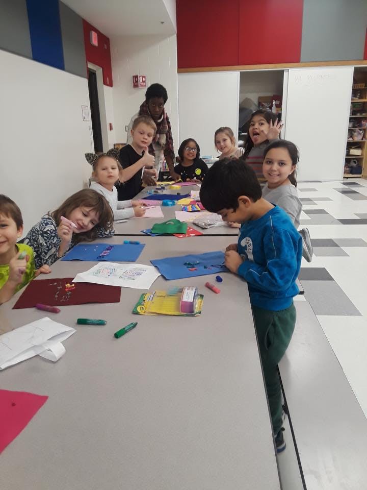 Children and teens at a table doing crafts