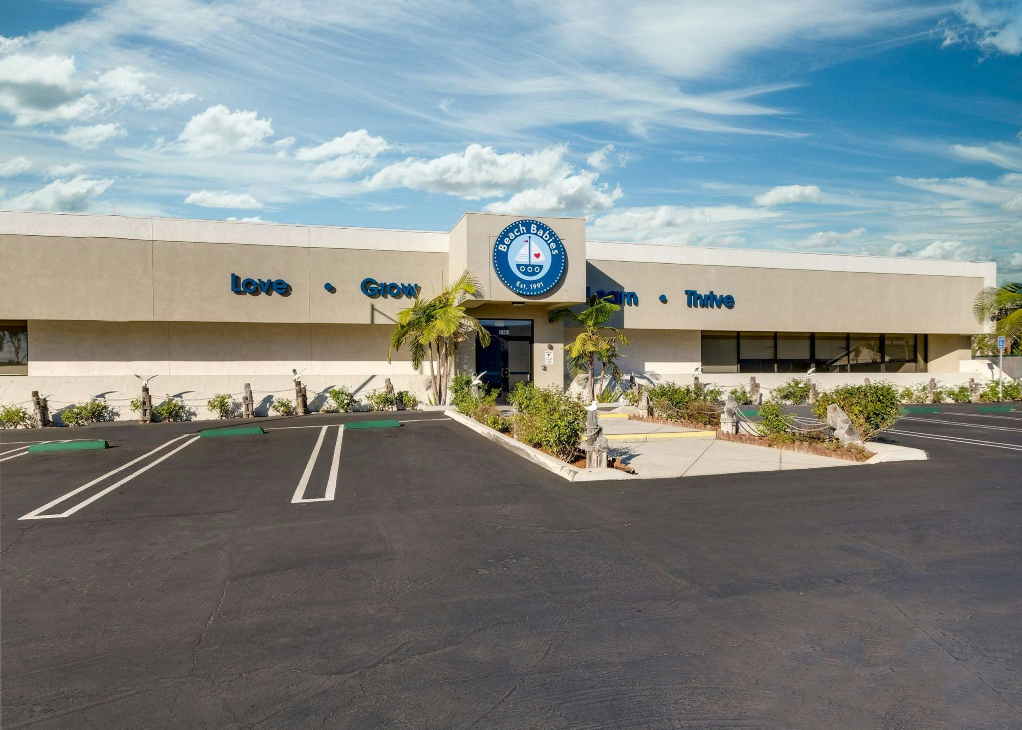 Exterior of a building with a sign that says "Love + Grow"