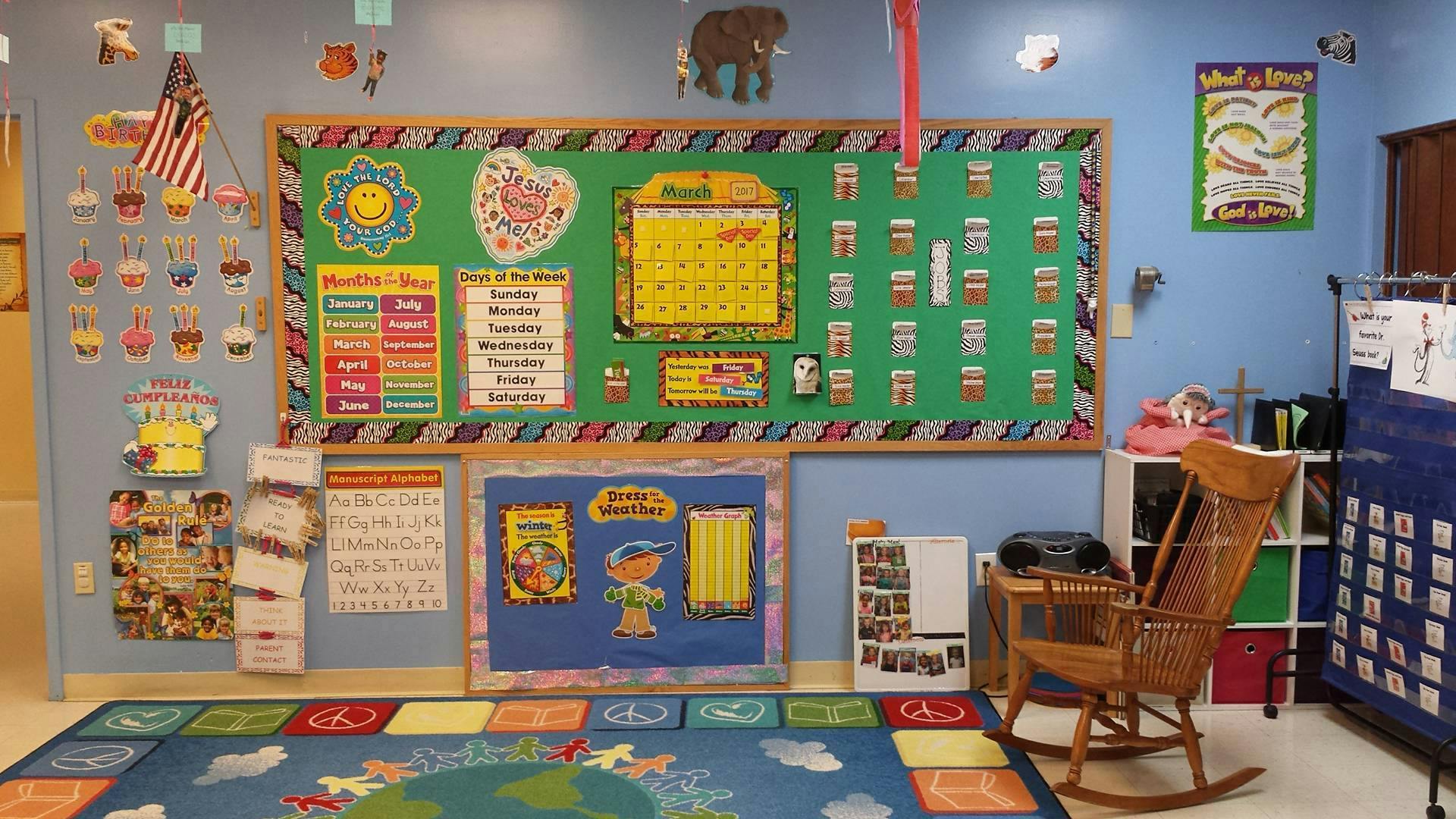 Classroom with bulletin boards, calendar, and rocking chair
