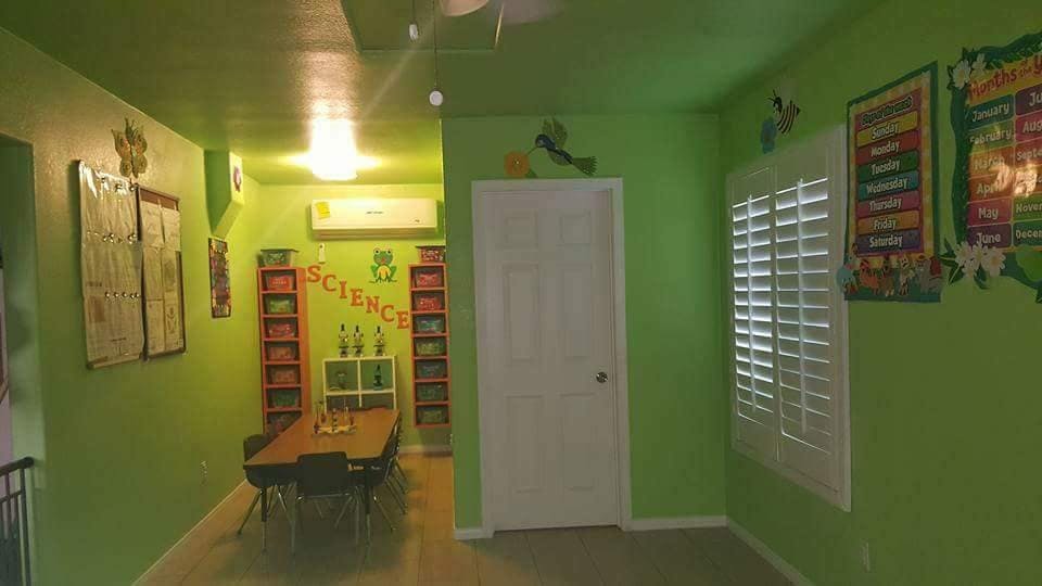 Green room with a table, chairs, bookshelves, and a "SCIENCE" banner