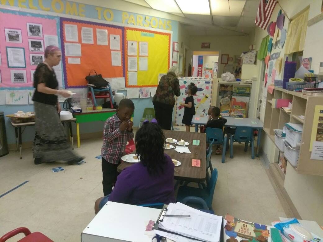 Adults and children in a classroom