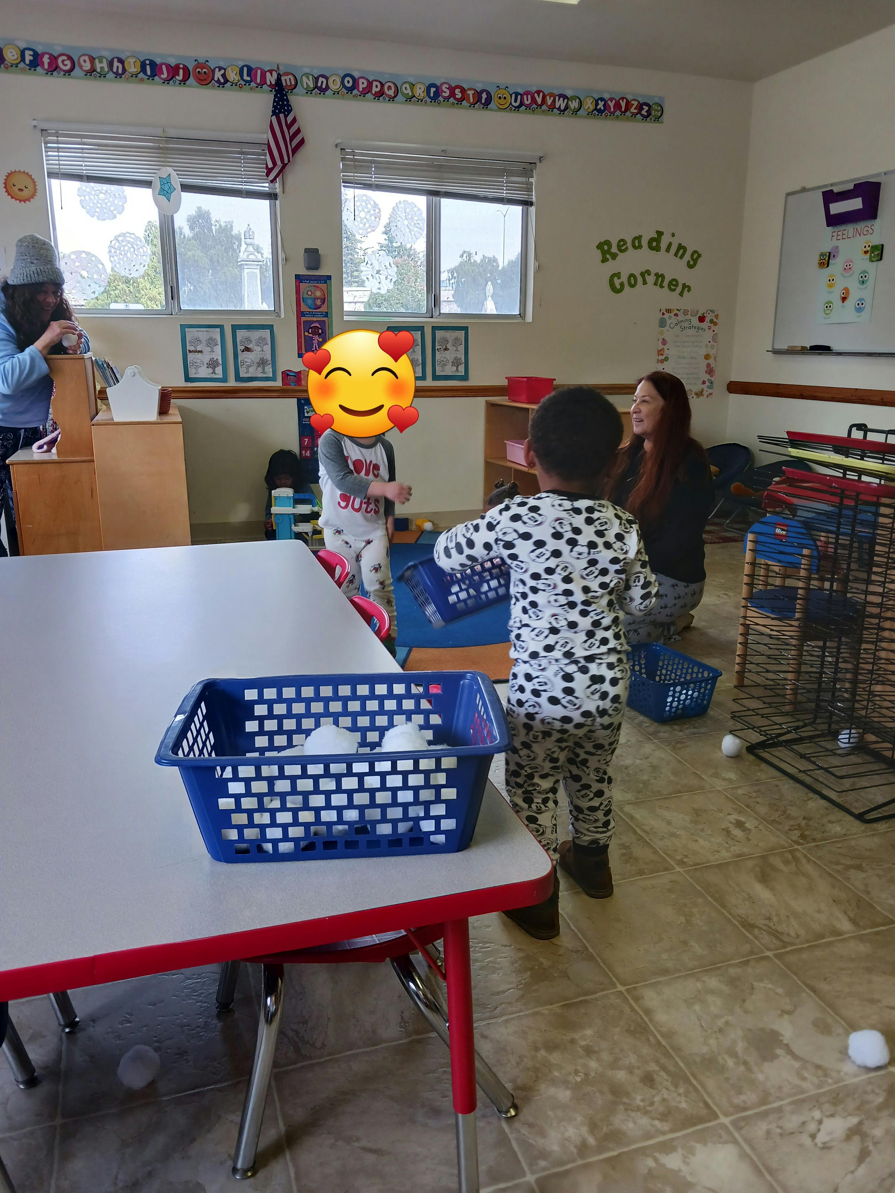 Two children and two adults in a classroom