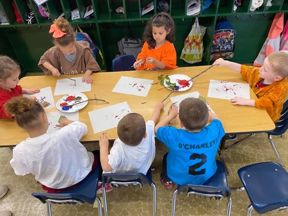 Children painting at a table