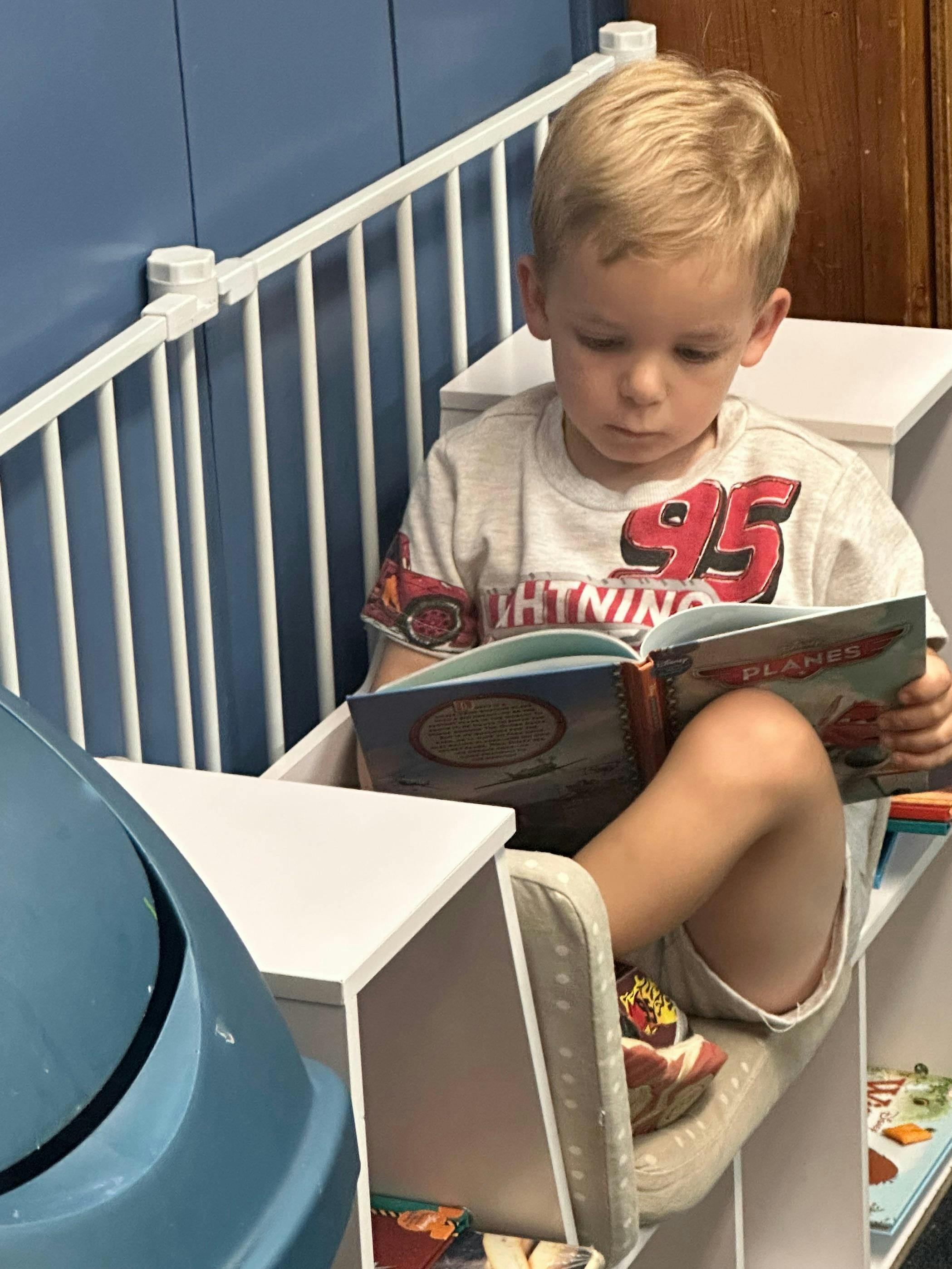 Child sitting and reading a book