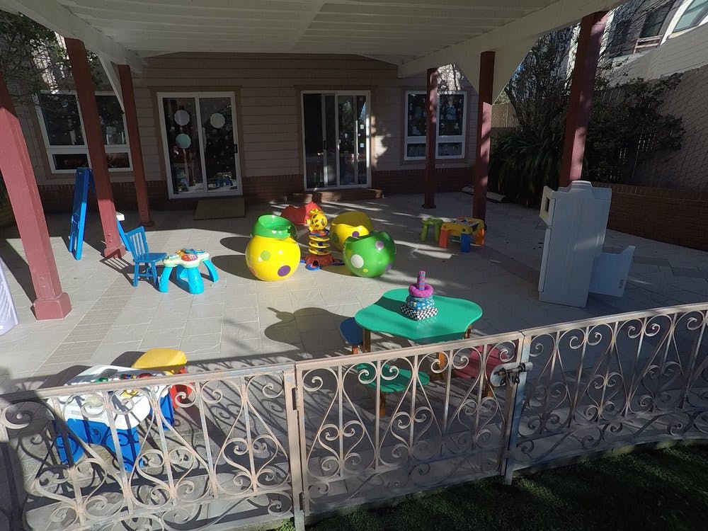 Outdoor play area with colorful toys and small tables