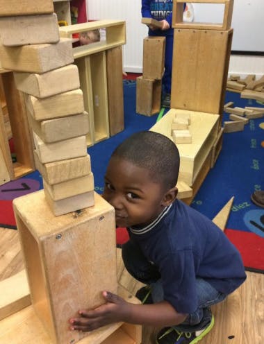 Child playing with wooden blocks