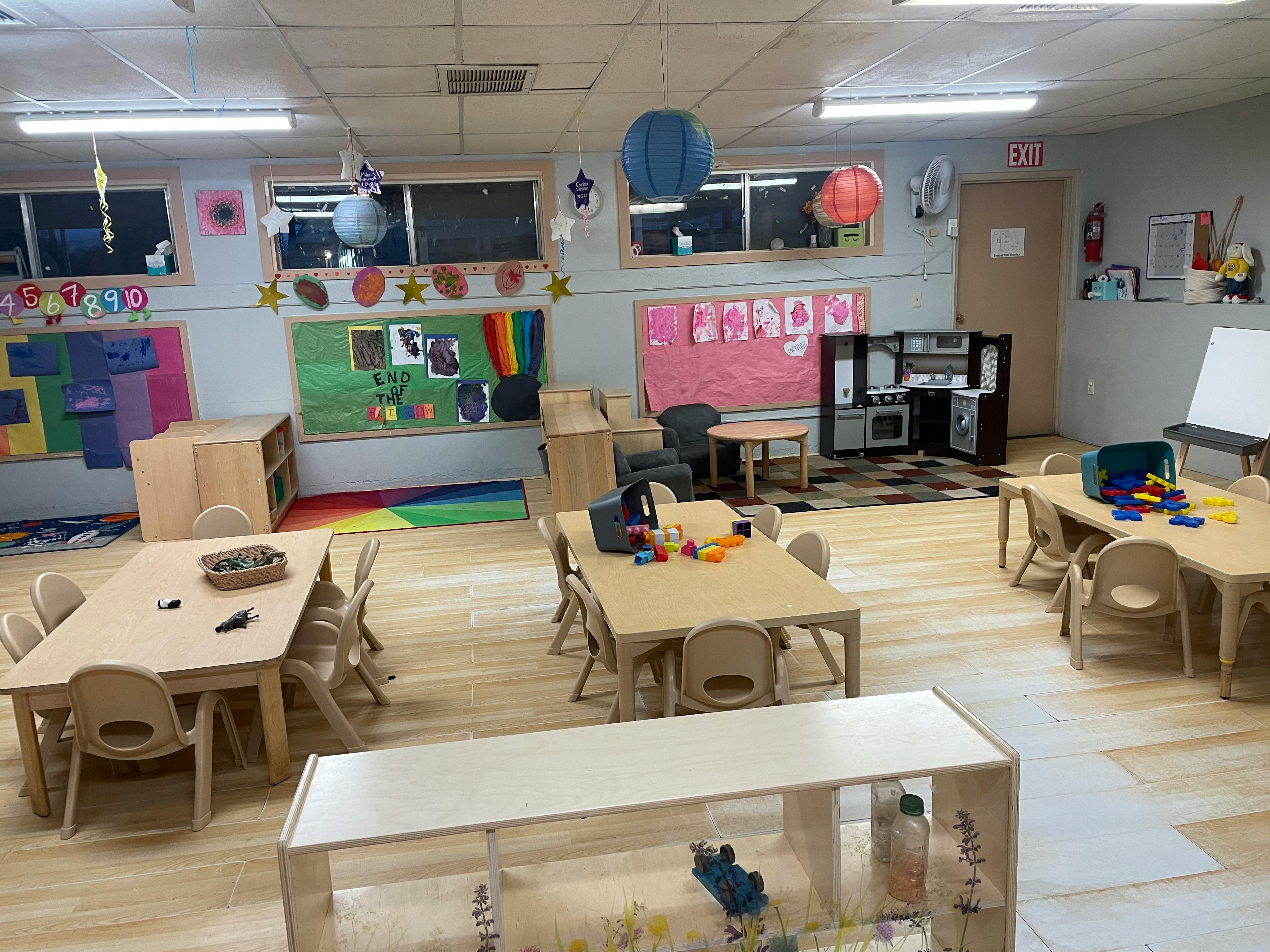 Empty classroom with small tables and chairs
