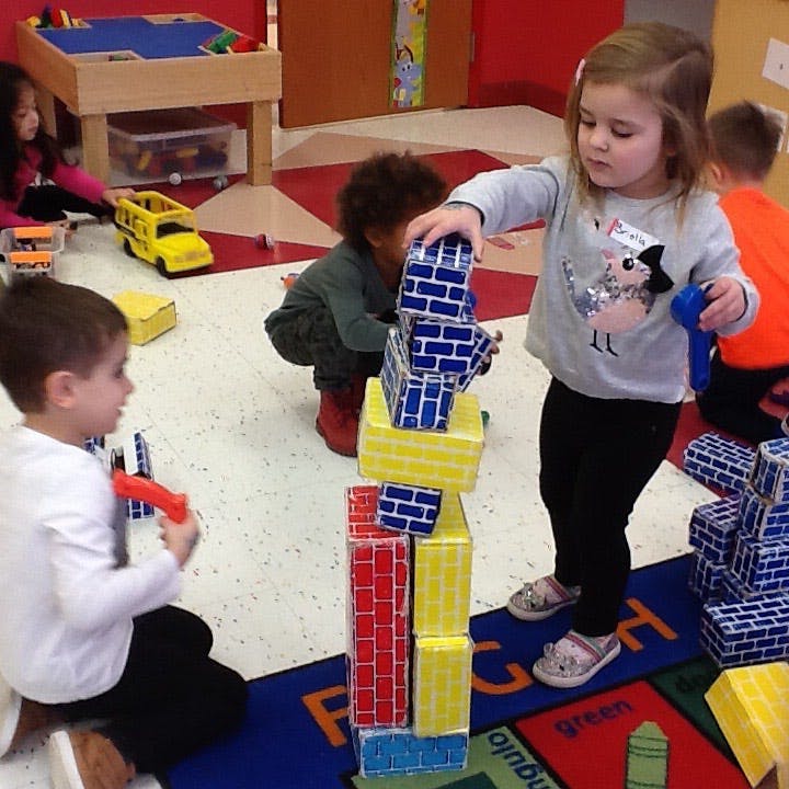 Children playing with building blocks in a classroom