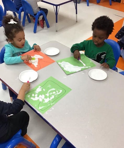 Children doing an art activity at a table