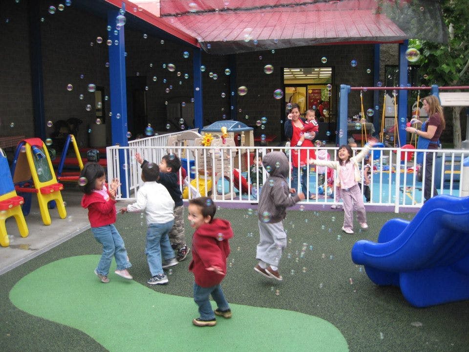 Children playing with bubbles on a playground