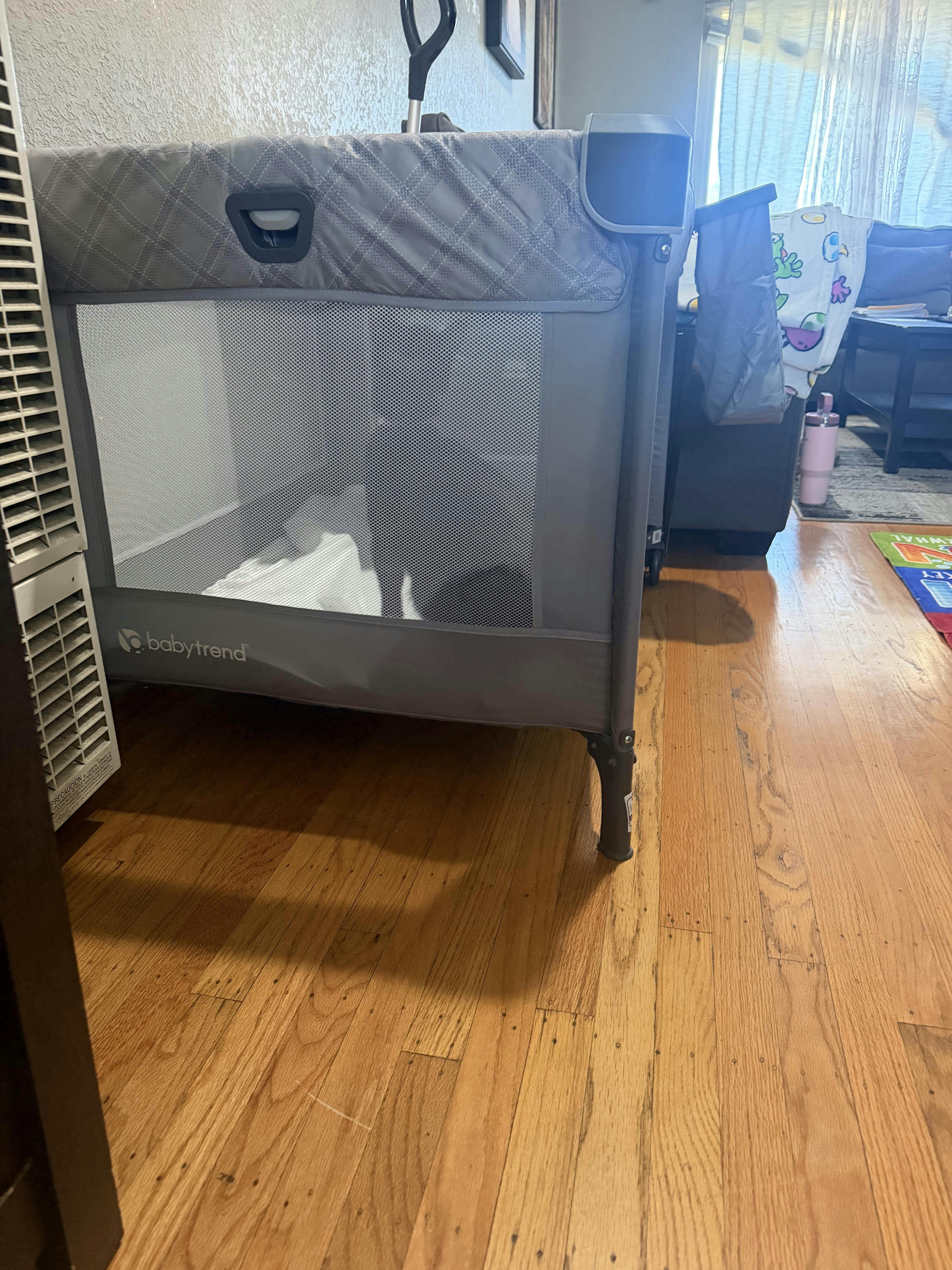 Baby Trend playard on a hardwood floor