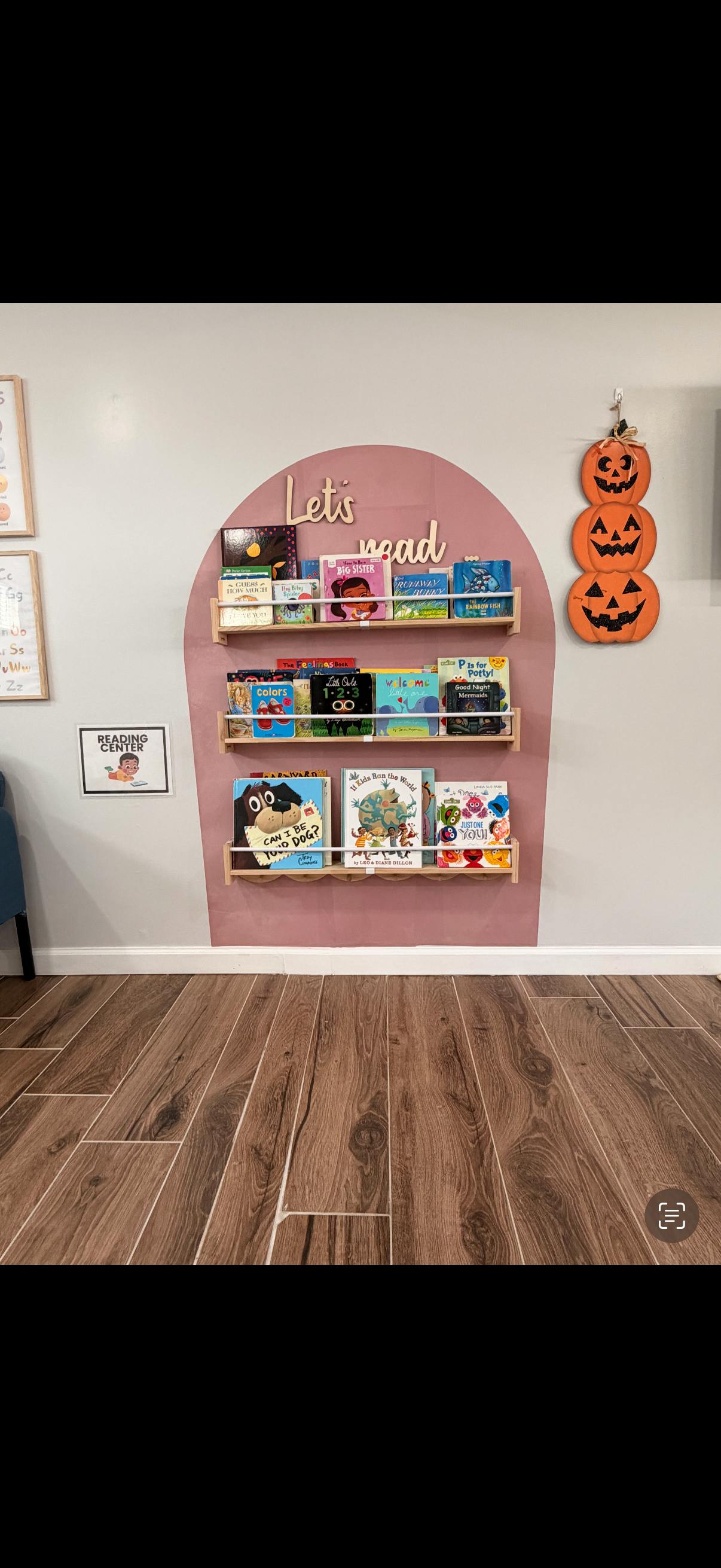 Bookshelves with children's books and a "Let's read" sign