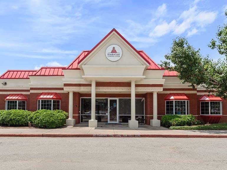 KinderCare Learning Center with a red roof and brick facade