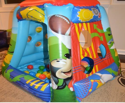 Inflatable play structure with colorful balls inside