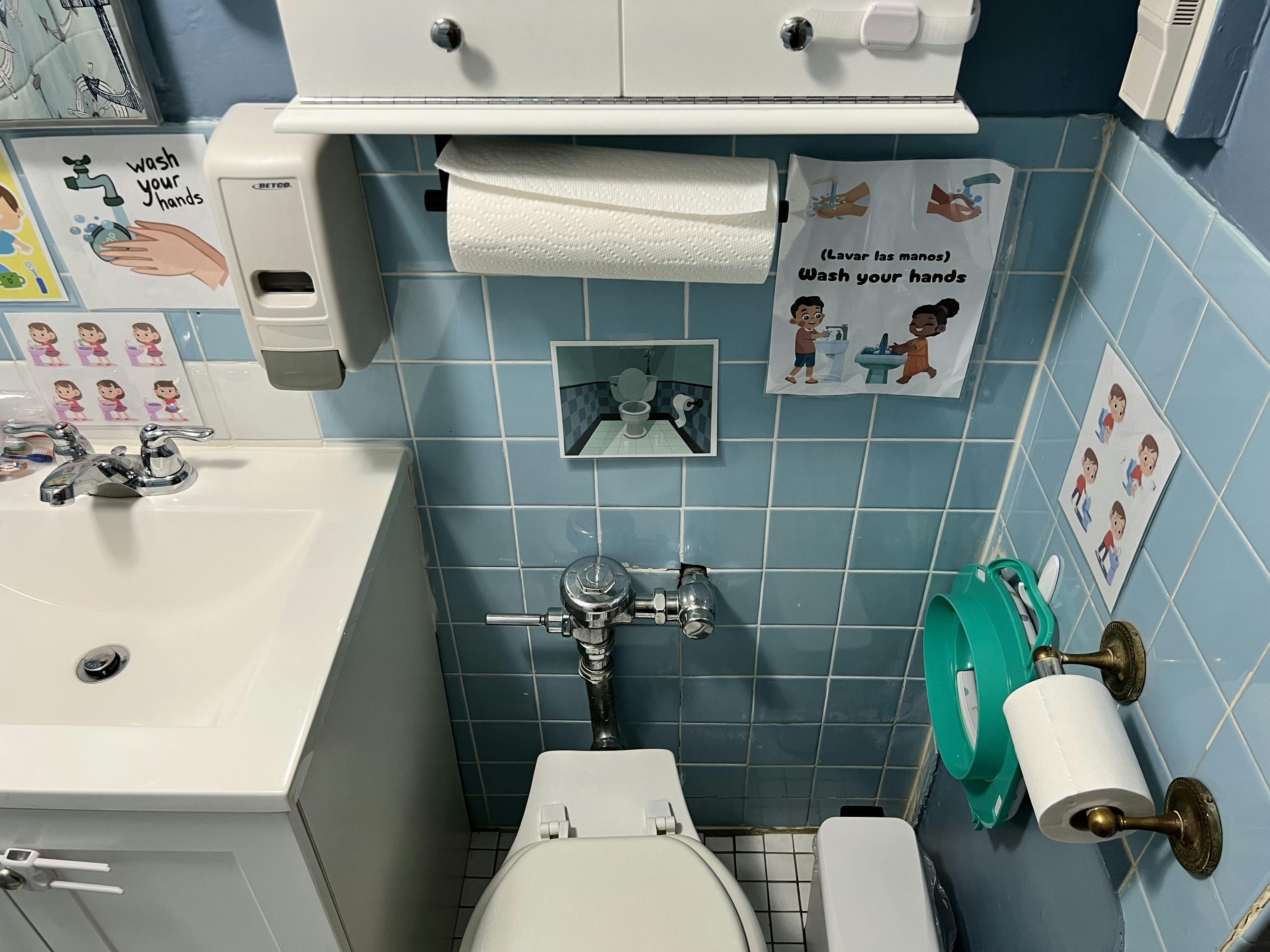 Bathroom with a toilet, sink, and blue tiled walls
