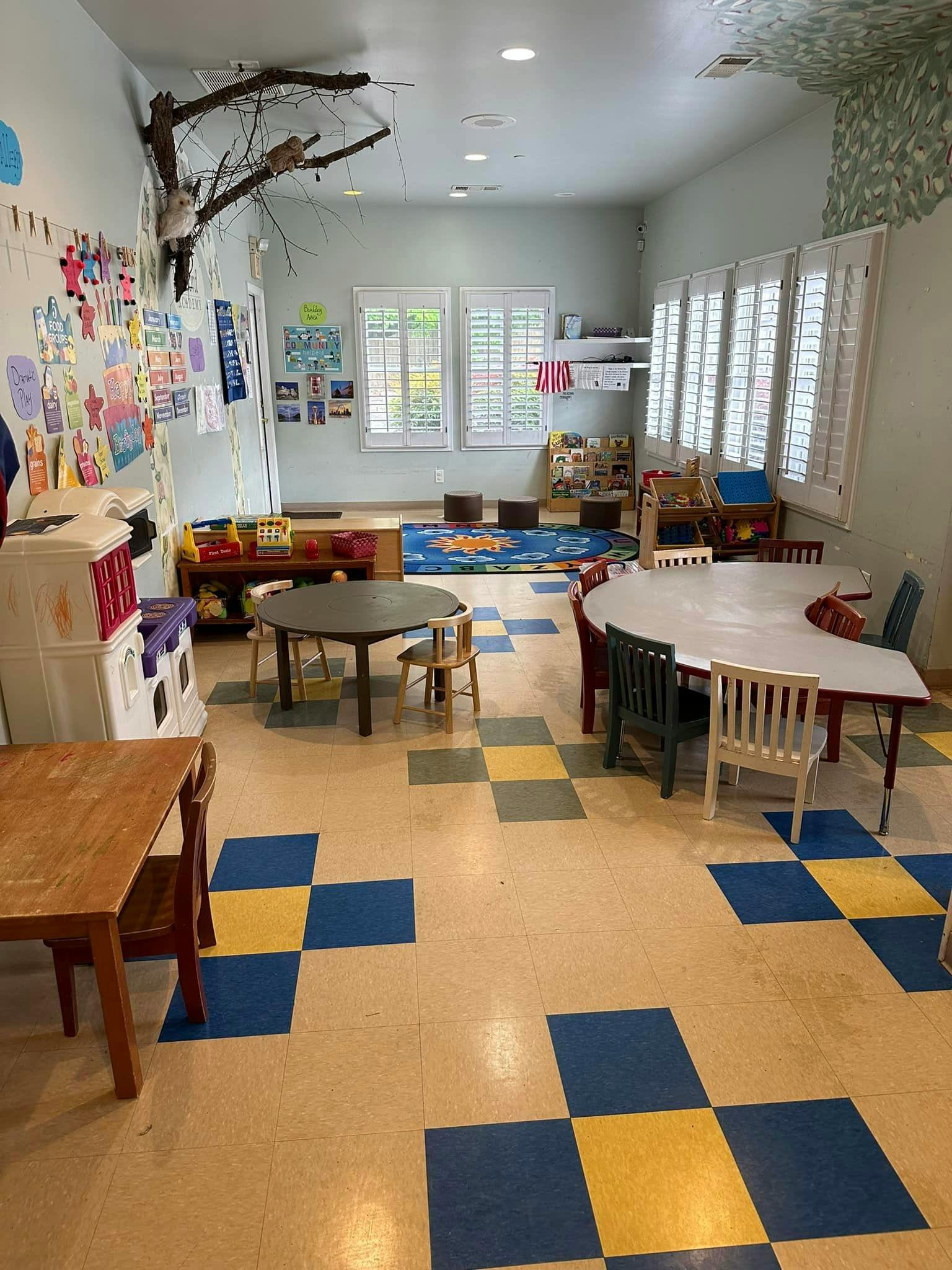 Classroom with tables, chairs, and art on the walls