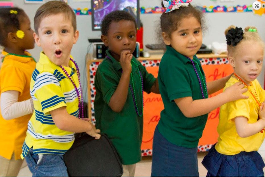 Children in a line, one child with mouth open