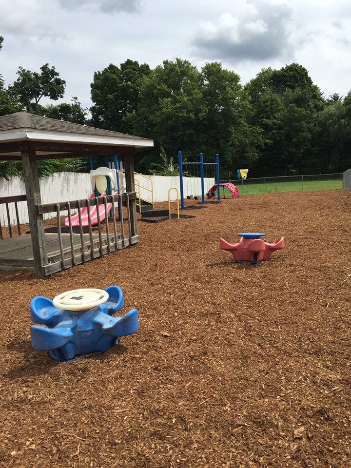 Playground with a gazebo, slides, and spring riders on wood chips