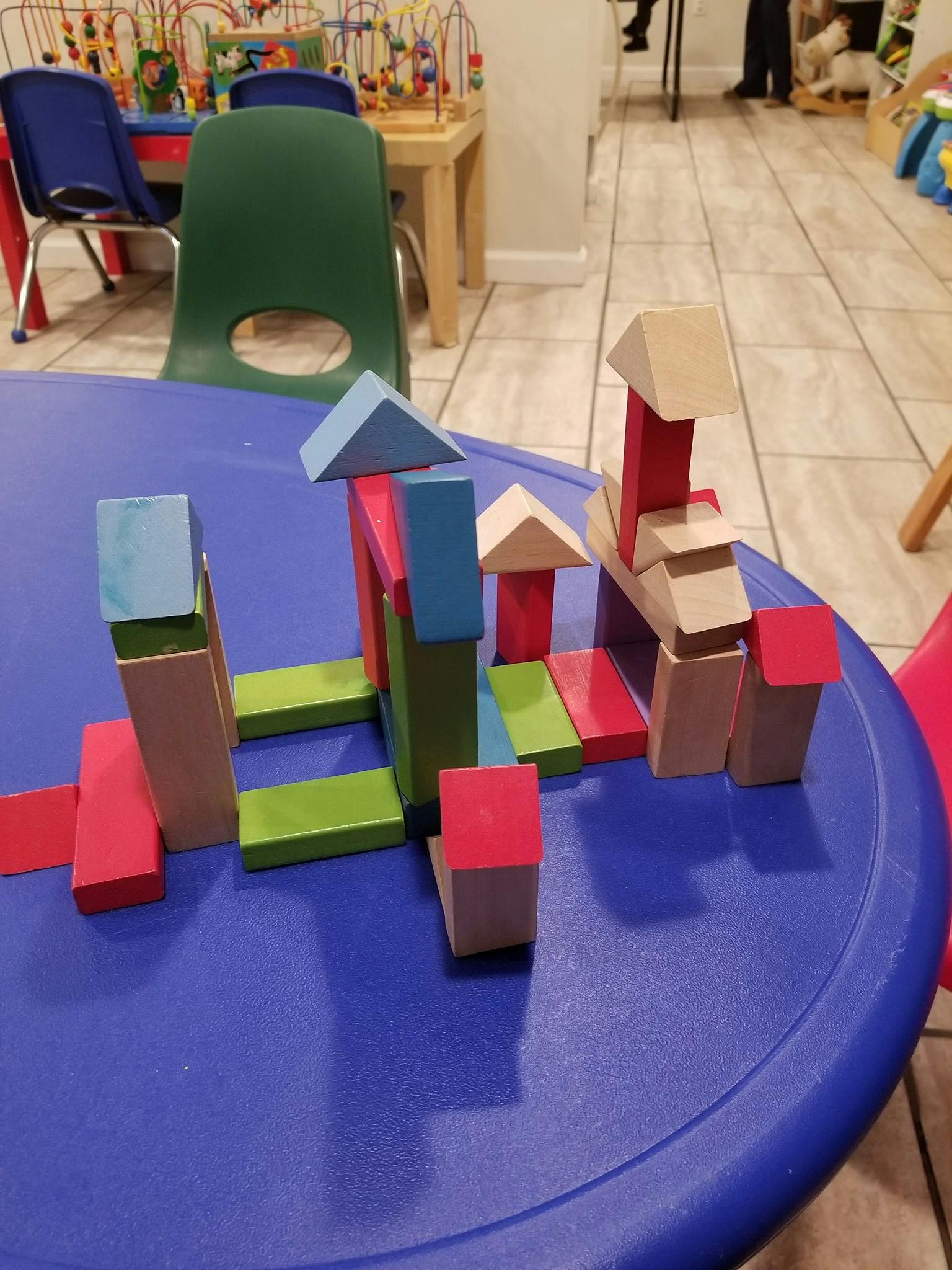 Colorful wooden blocks arranged on a blue table