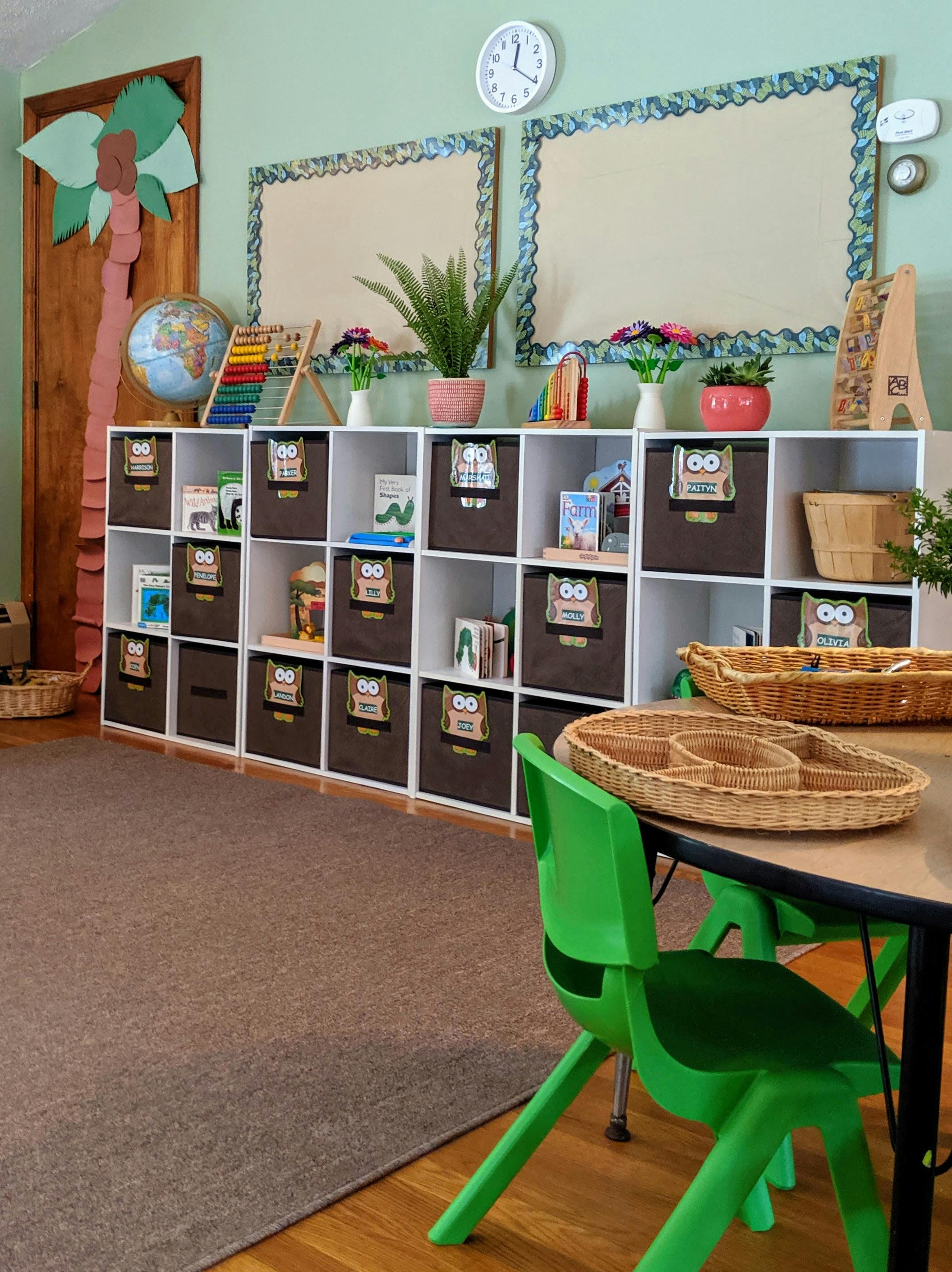 Classroom with storage cubbies, bulletin boards, and green chairs