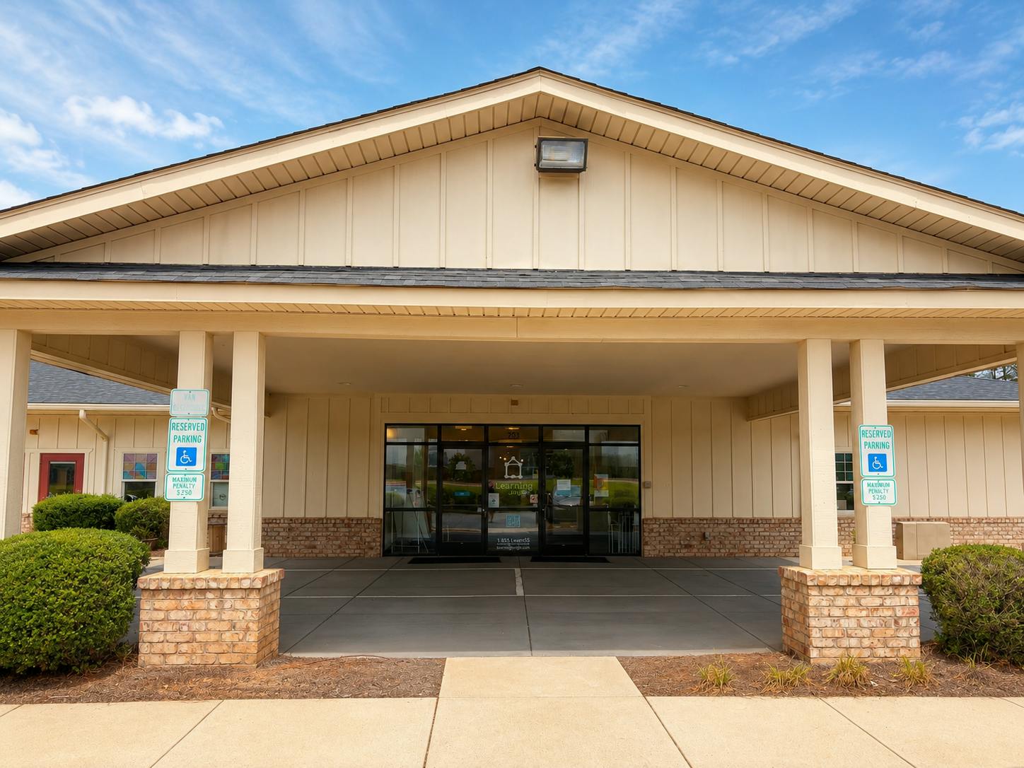 Entrance to a commercial building with reserved handicap parking signs
