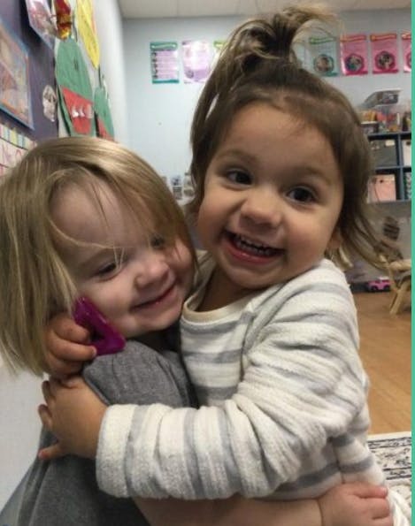 Two children hugging