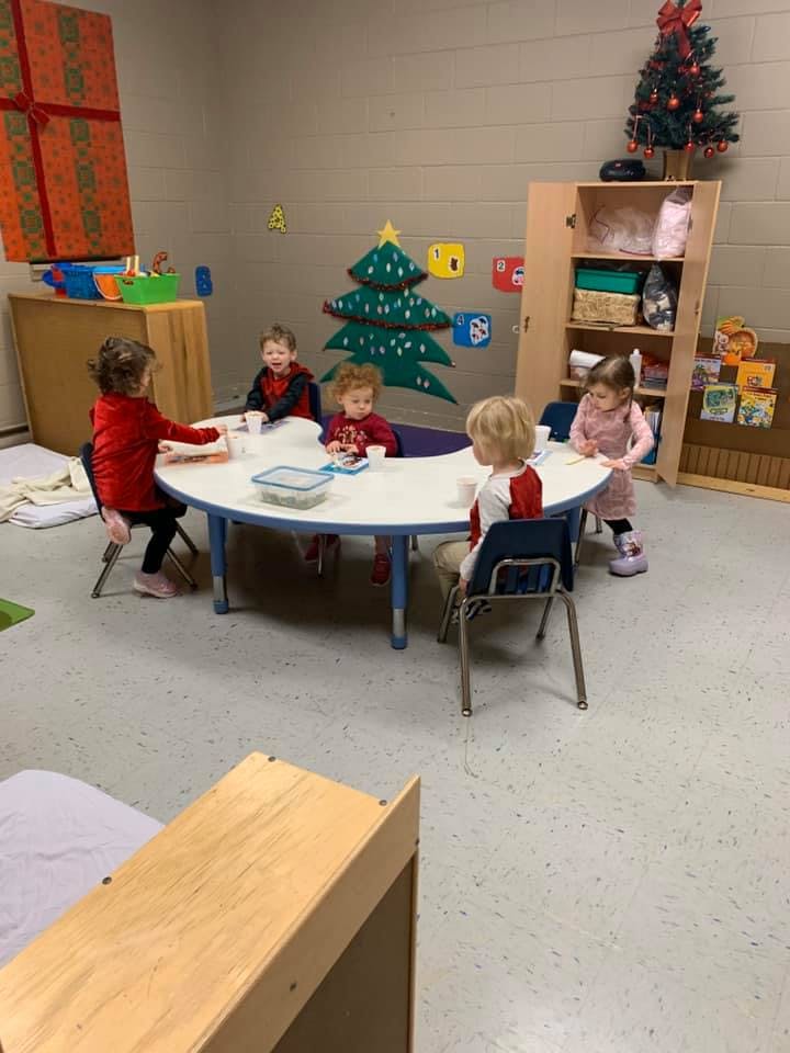 Children sitting around a round table in a classroom