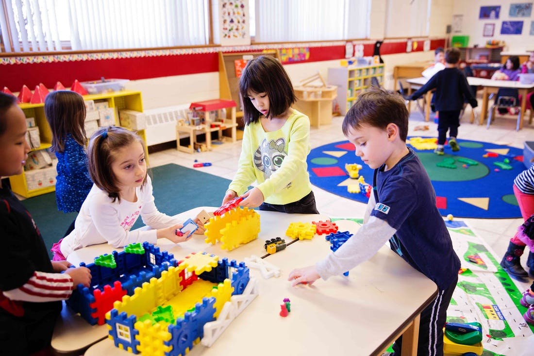 Children playing with building blocks in a classroom