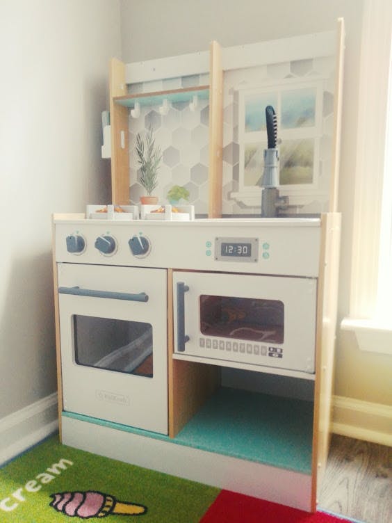 Child's play kitchen with oven, microwave, and sink