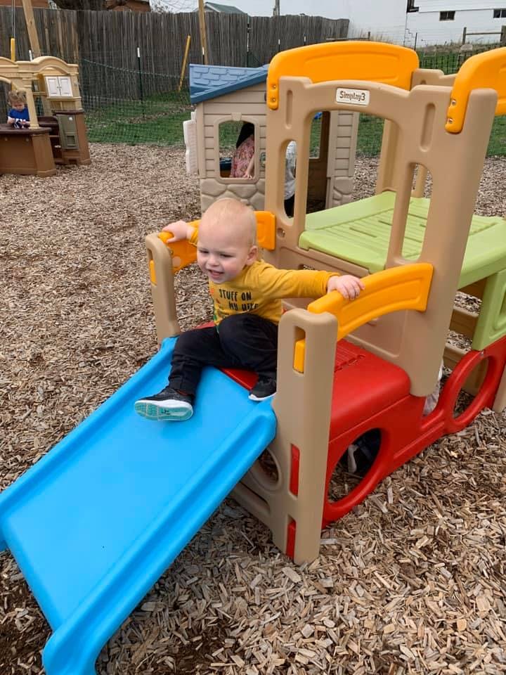 Child on a blue slide on a playground