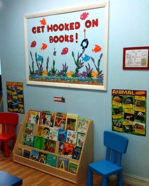 Bookshelf with children's books and a bulletin board that says "Get Hooked on Books!"